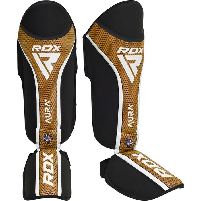 RDX Aura+ T17 protectores de espinillas y empeine, negro-dorado
