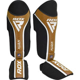 RDX Aura+ T17 protectores de espinillas y empeine, negro-dorado