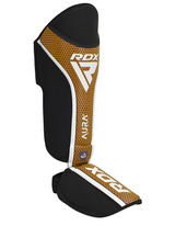 RDX Aura+ T17 protectores de espinillas y empeine, negro-dorado